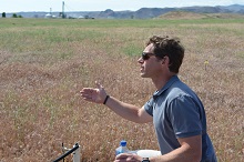 photo of Matt Germino speaking in a field of cheatgrass